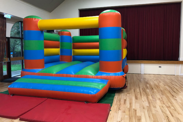 Uplyme Village Hall main hall with bouncy castle Uplyme Village Hall with a bouncy castle